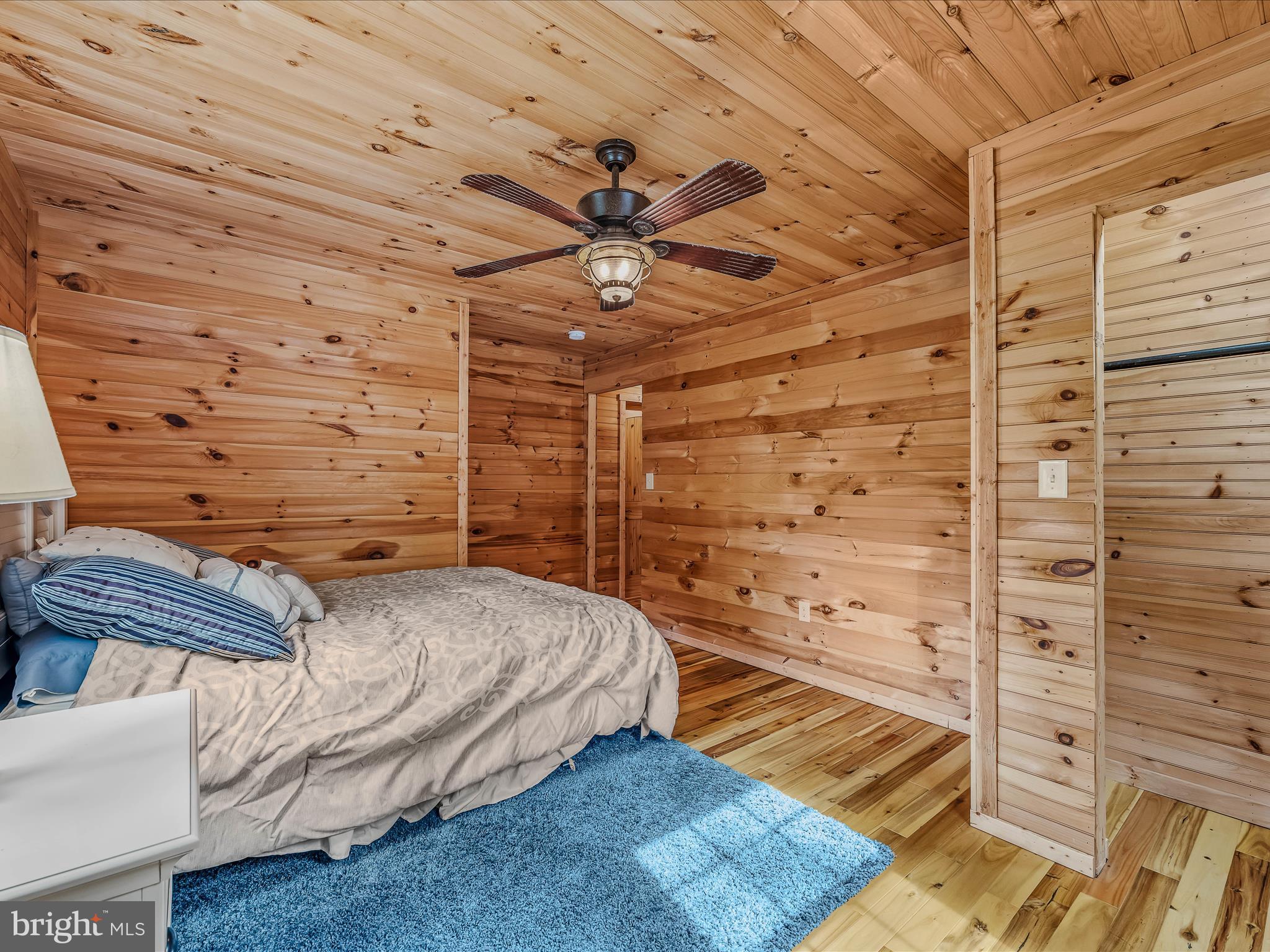 79 Whiskey Still Road Berkeley Springs, WV 25411 - Photo 33 of 59 a bedroom with a bed and a walk in closet