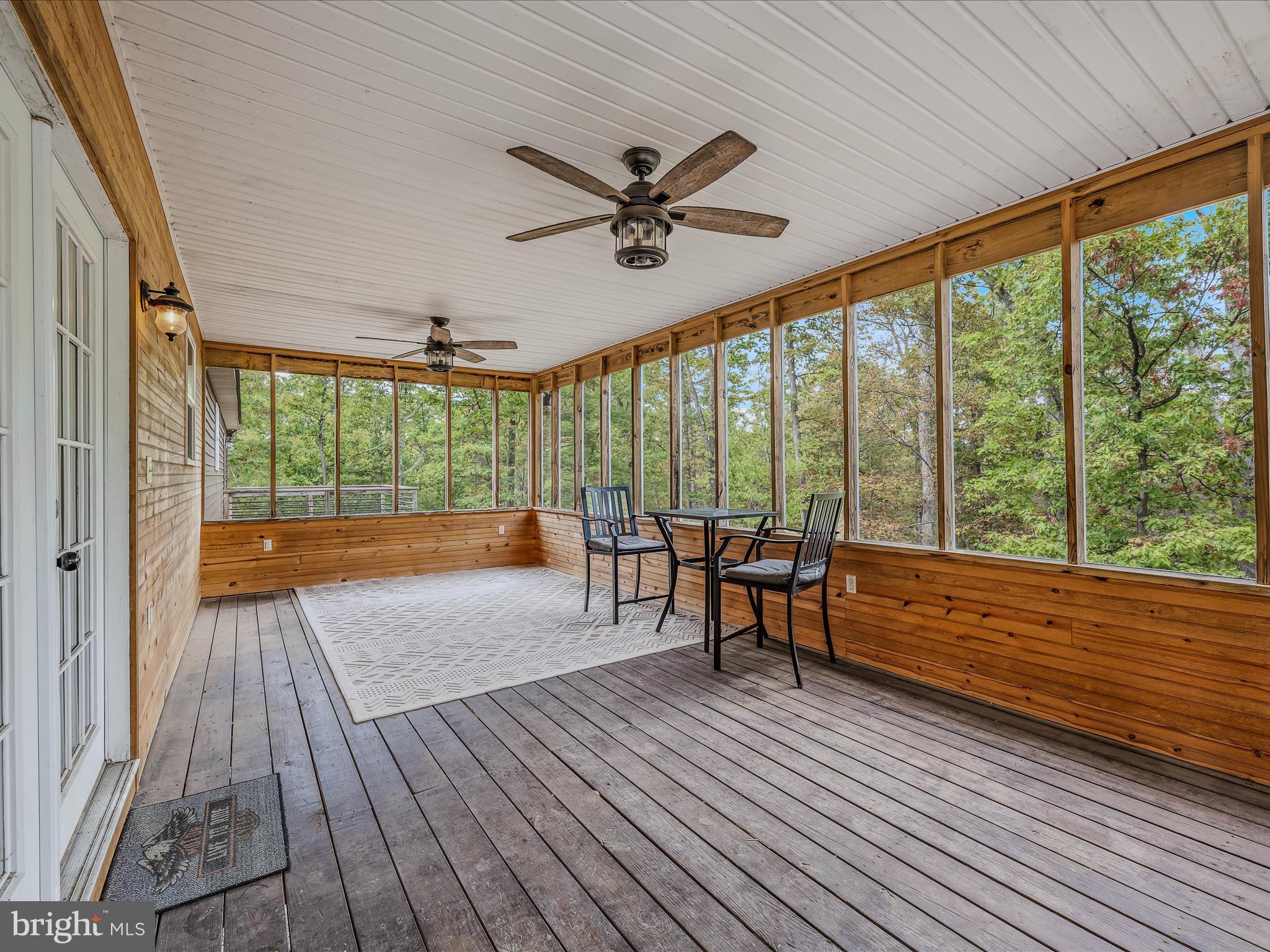 79 Whiskey Still Road Berkeley Springs, WV 25411 - Photo 34 of 59 a view of a porch with wooden floor and outdoor space