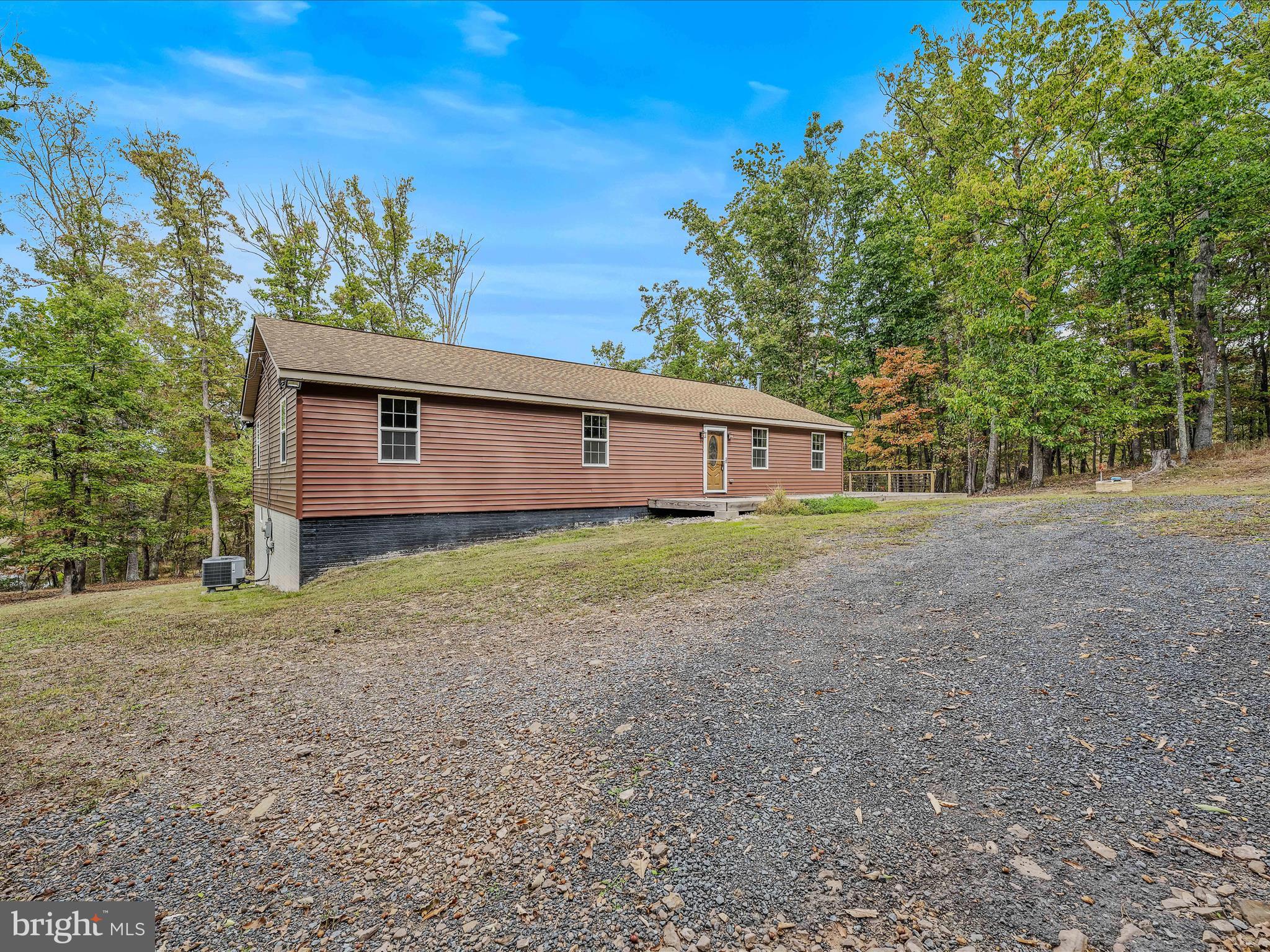 79 Whiskey Still Road Berkeley Springs, WV 25411 - Photo 43 of 59 a view of a house with a backyard