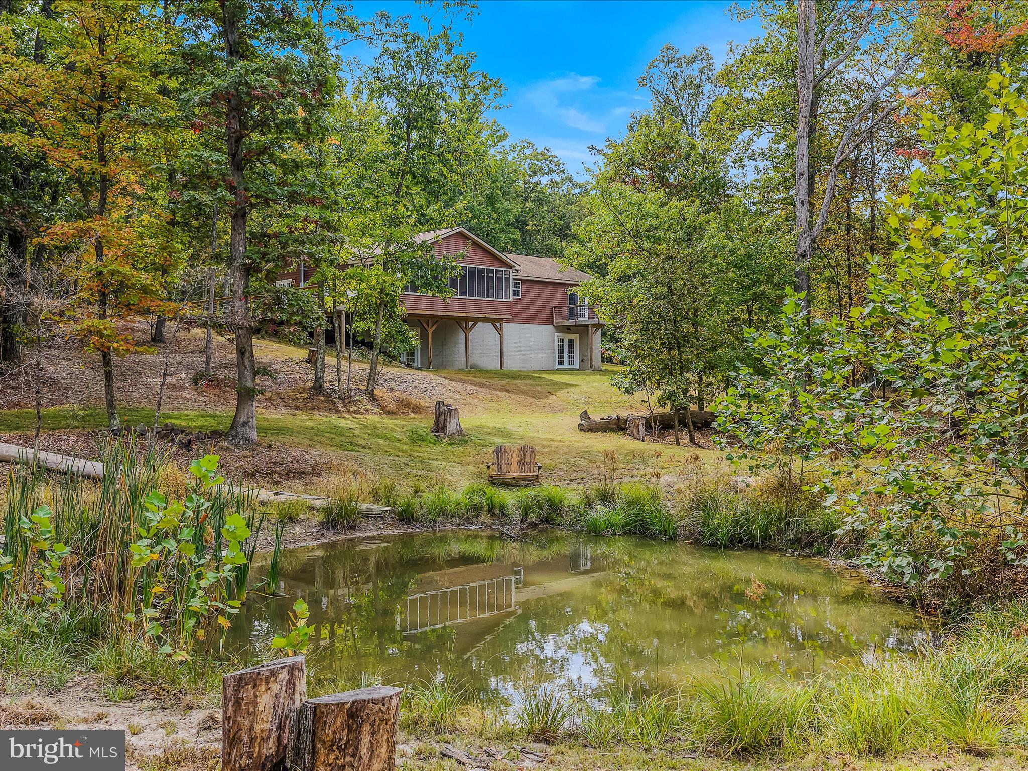 79 Whiskey Still Road Berkeley Springs, WV 25411 - Photo 45 of 59 a view of a house with a yard