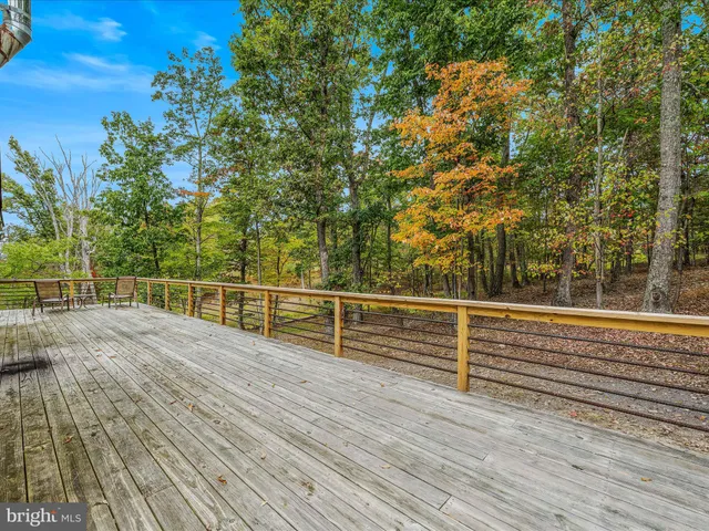 a view of a roof deck with wooden floor and fence