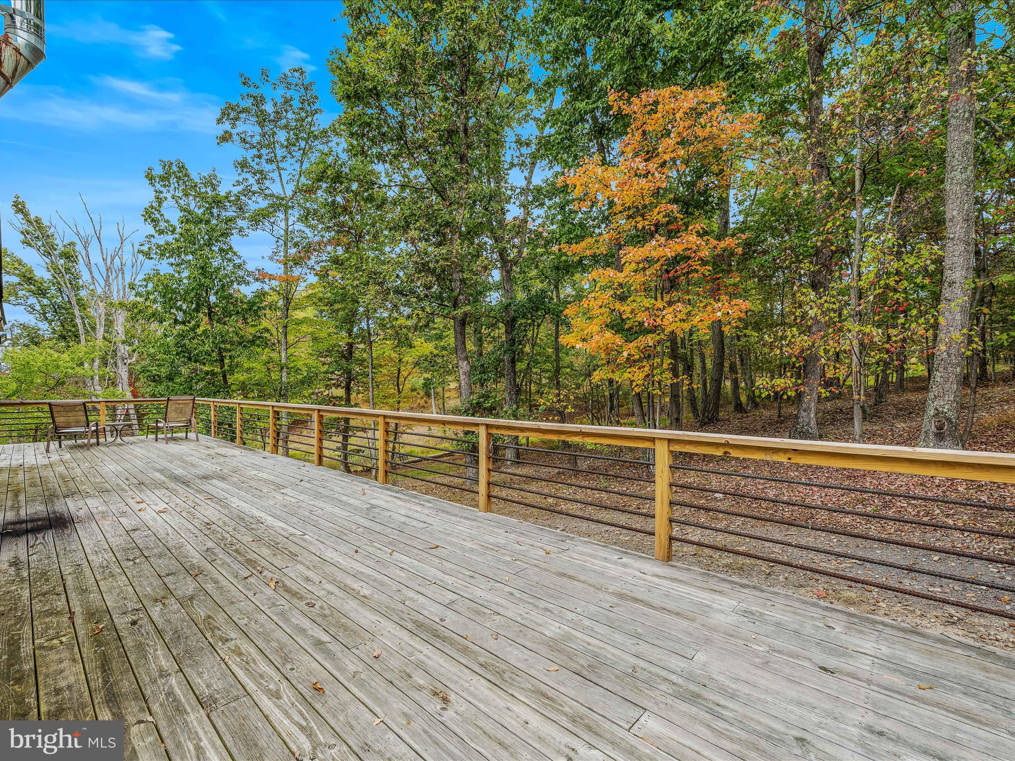 79 Whiskey Still Road Berkeley Springs, WV 25411 - Photo 7 of 59 a view of a roof deck with wooden floor and fence