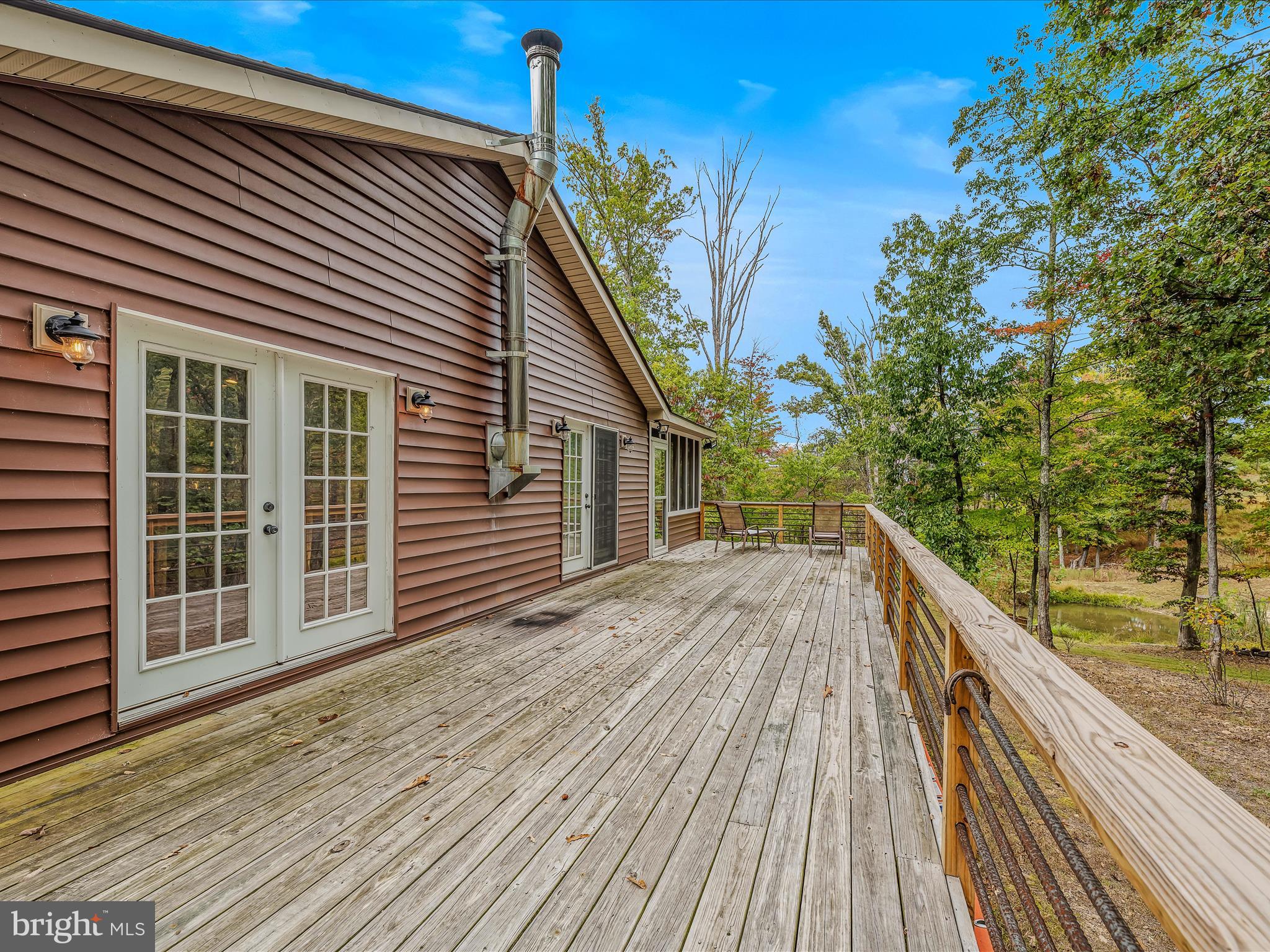 79 Whiskey Still Road Berkeley Springs, WV 25411 - Photo 8 of 59 a view of deck with a lake view