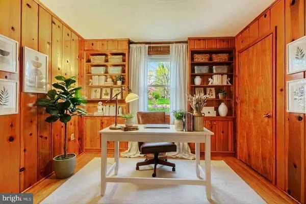a view of empty room with wooden floor and fireplace