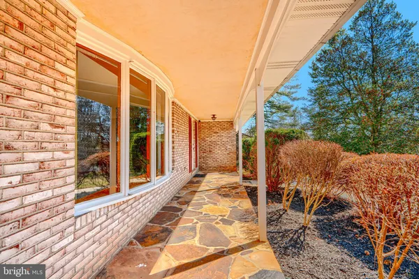 a kitchen with stainless steel appliances granite countertop a refrigerator a sink and dishwasher with wooden floor