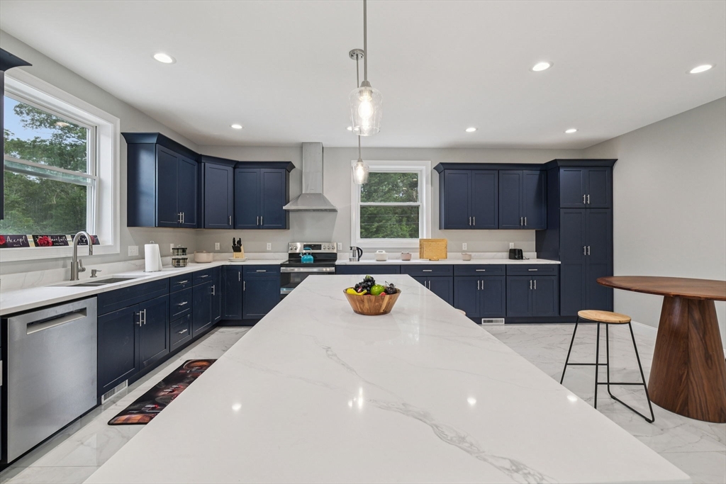 920 Drift Road Westport, MA 02790 - Photo 18 of 41 a kitchen with a sink a center island cabinets and a window