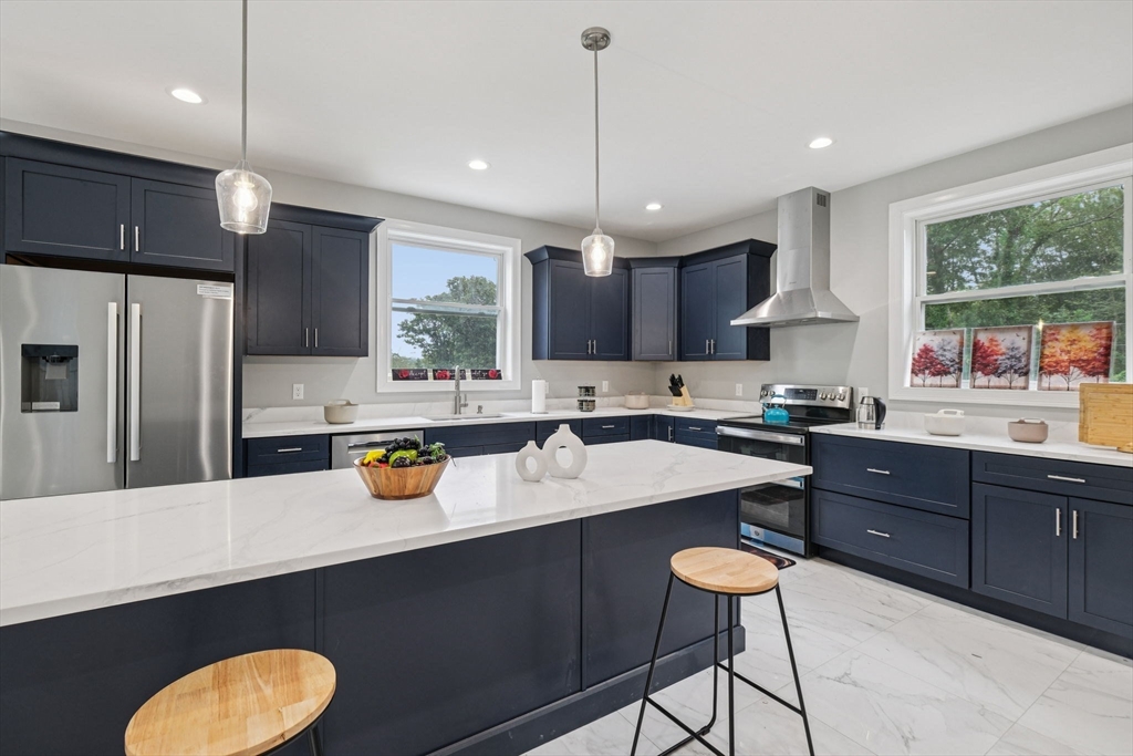 920 Drift Road Westport, MA 02790 - Photo 2 of 41 a kitchen with a sink a center island cabinets and stainless steel appliances