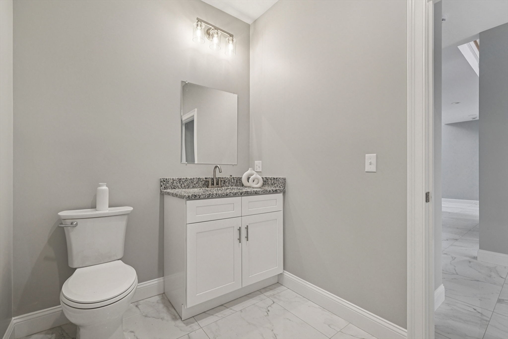 920 Drift Road Westport, MA 02790 - Photo 24 of 41 a bathroom with a toilet a sink and mirror