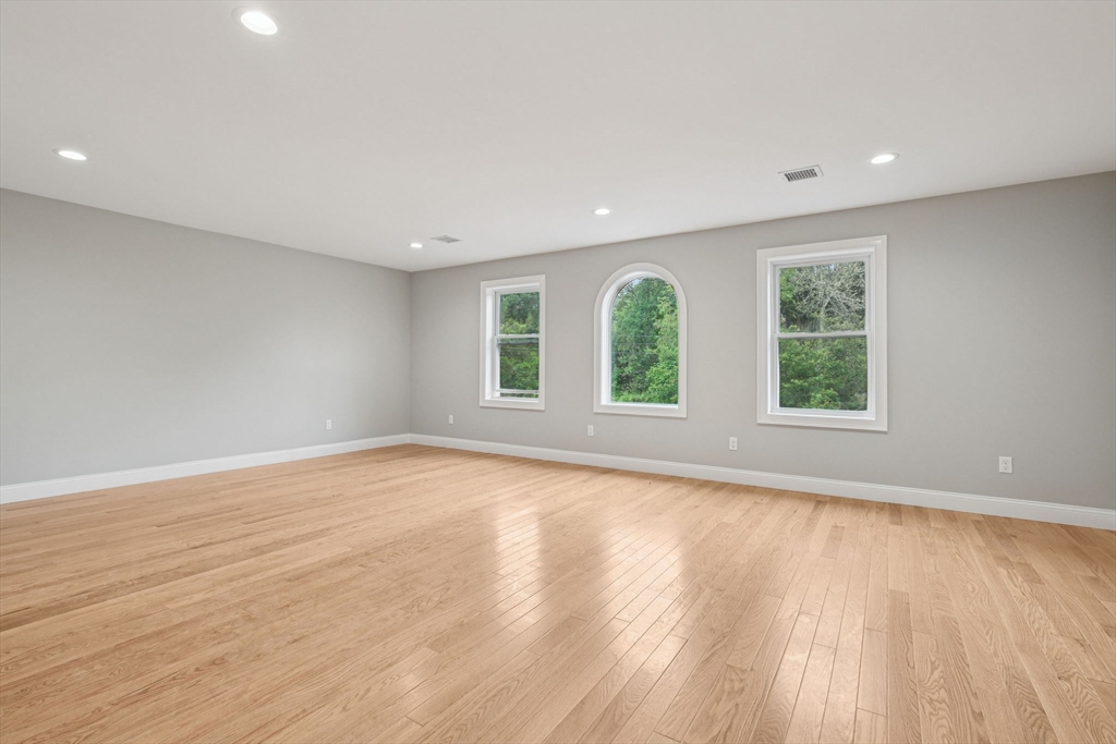 920 Drift Road Westport, MA 02790 - Photo 31 of 41 an empty room with wooden floor and windows