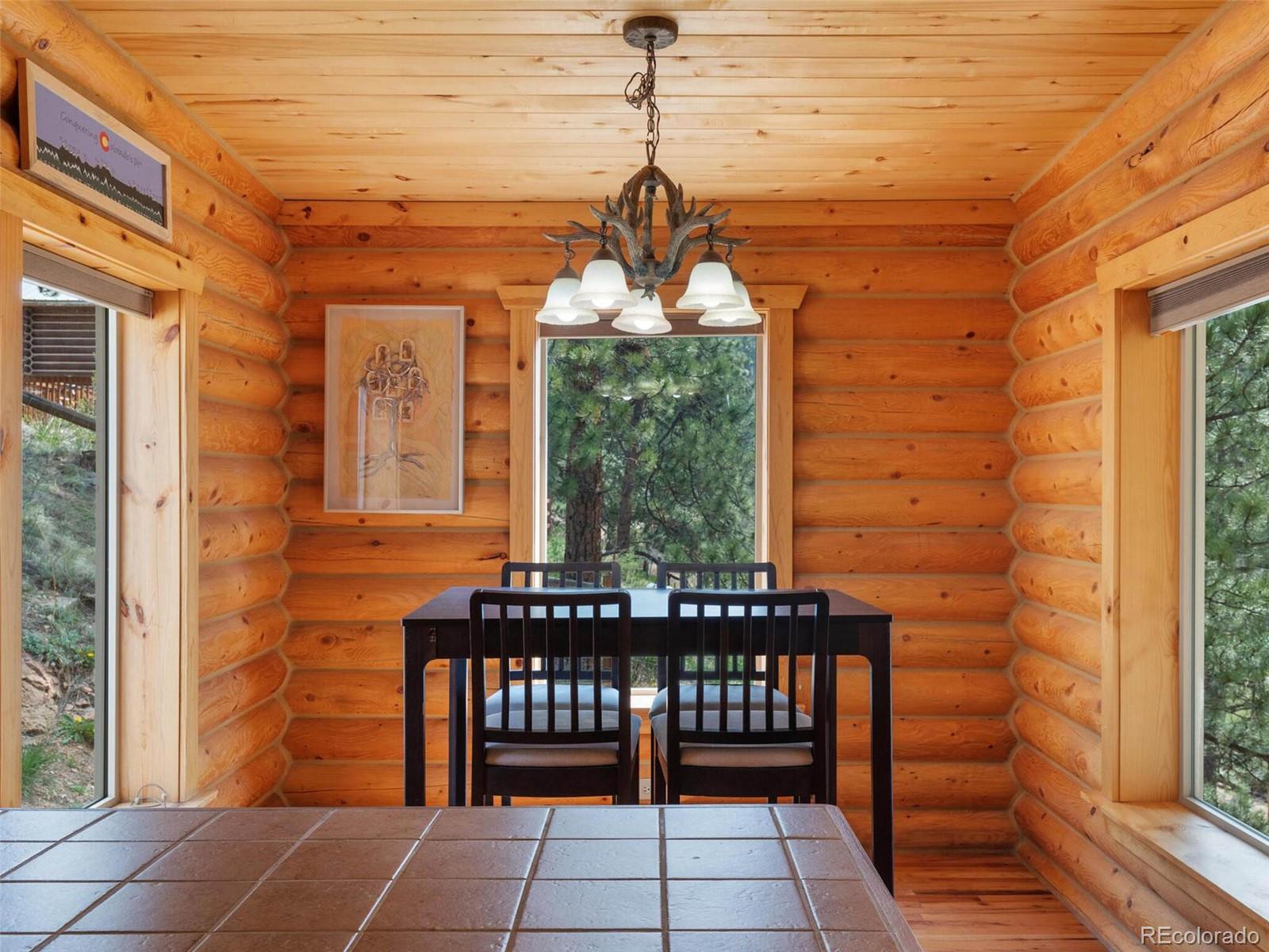 603 Old State Road Bailey, CO 80421 - Photo 15 of 40 a front view of a house with a bench