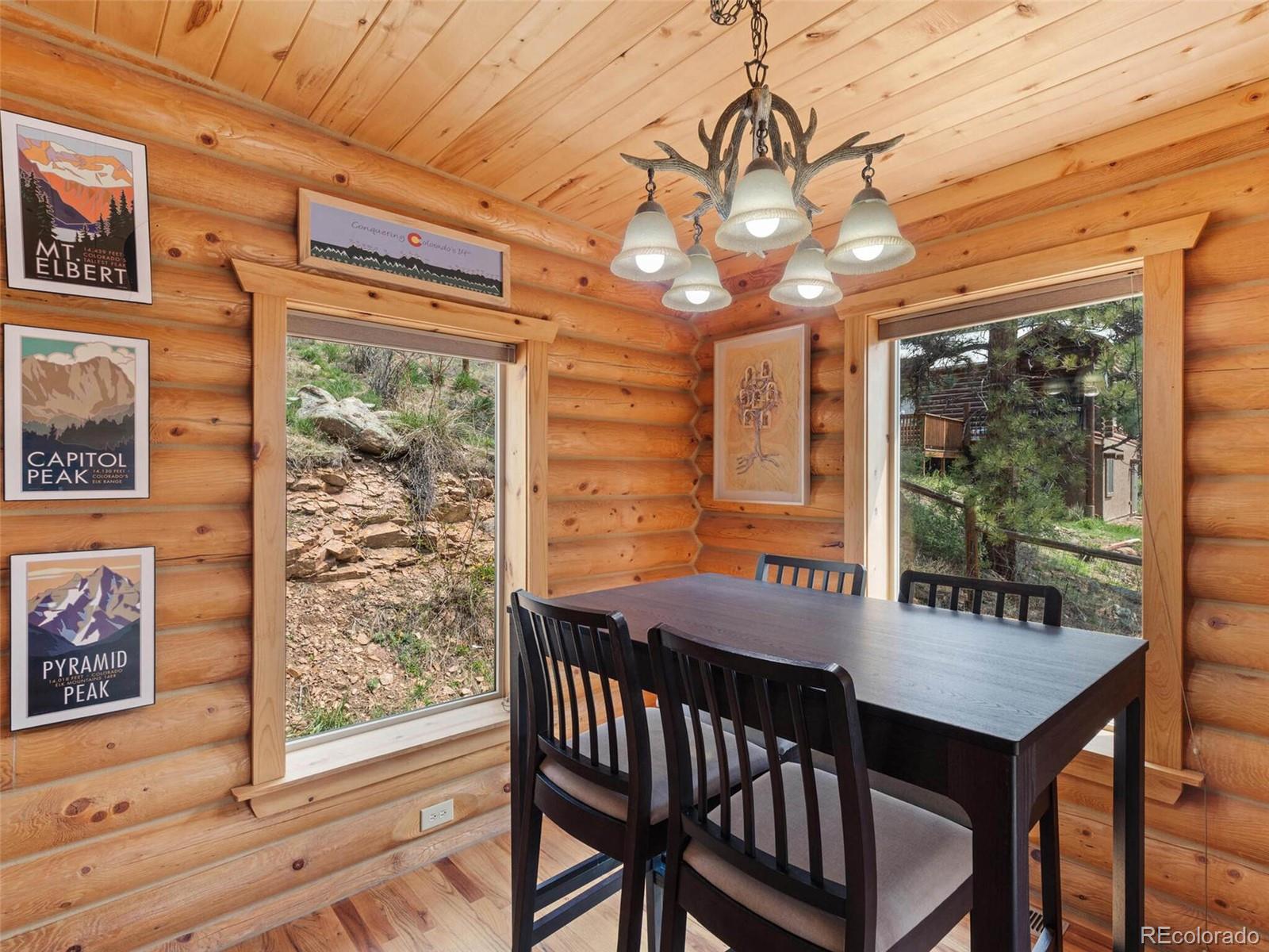 603 Old State Road Bailey, CO 80421 - Photo 16 of 40 a view of a dining room with furniture window and outside view
