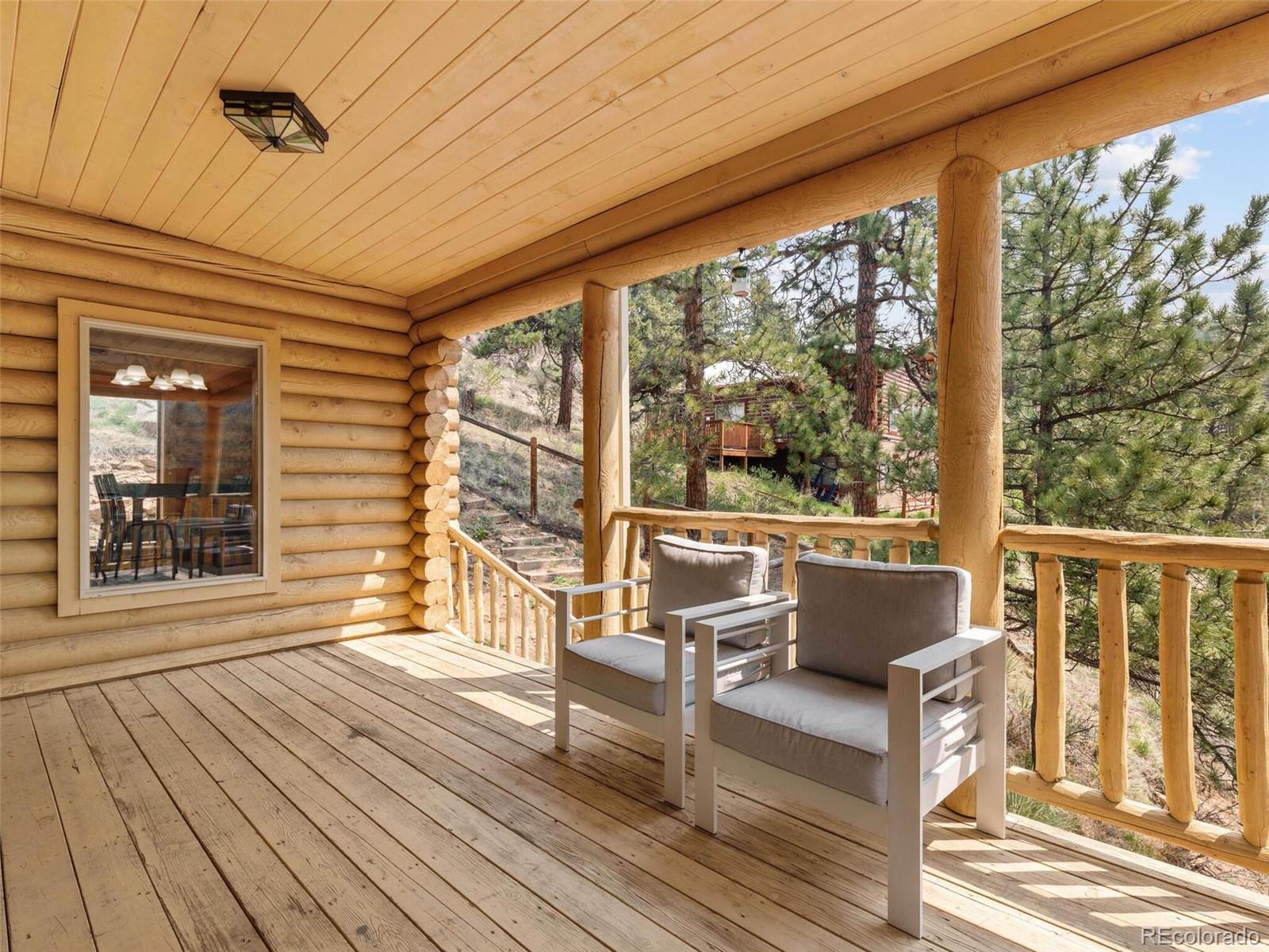 603 Old State Road Bailey, CO 80421 - Photo 20 of 40 a view of a two chairs in the balcony