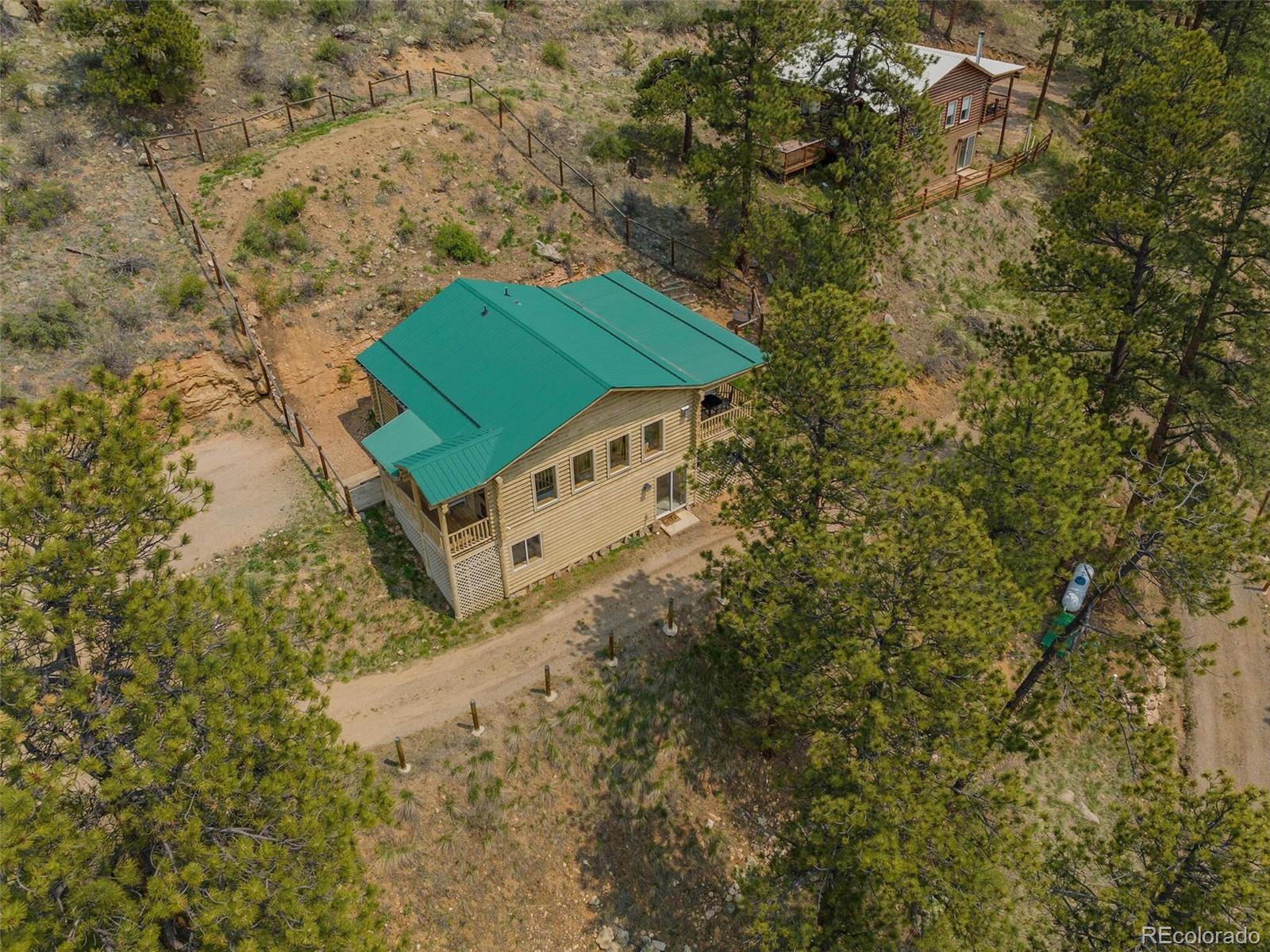603 Old State Road Bailey, CO 80421 - Photo 2 of 40 a green field with trees in the background
