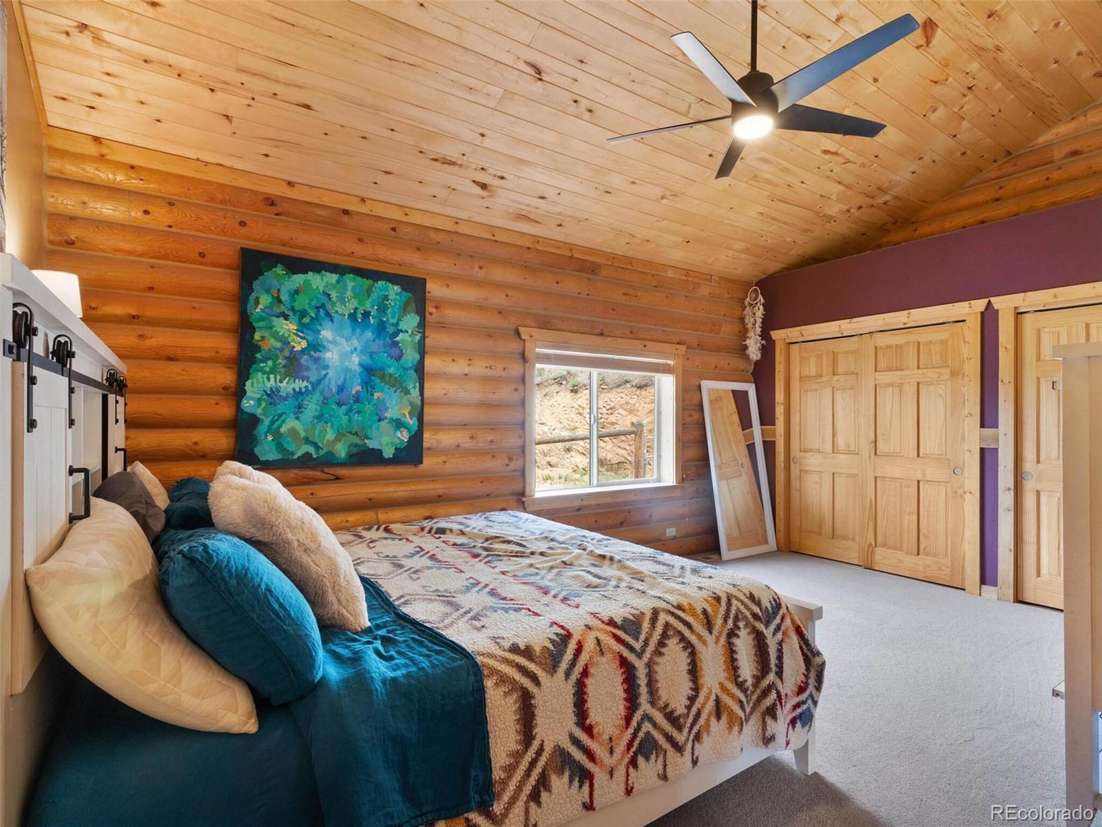 603 Old State Road Bailey, CO 80421 - Photo 24 of 40 a bed sitting in a bedroom next to a window