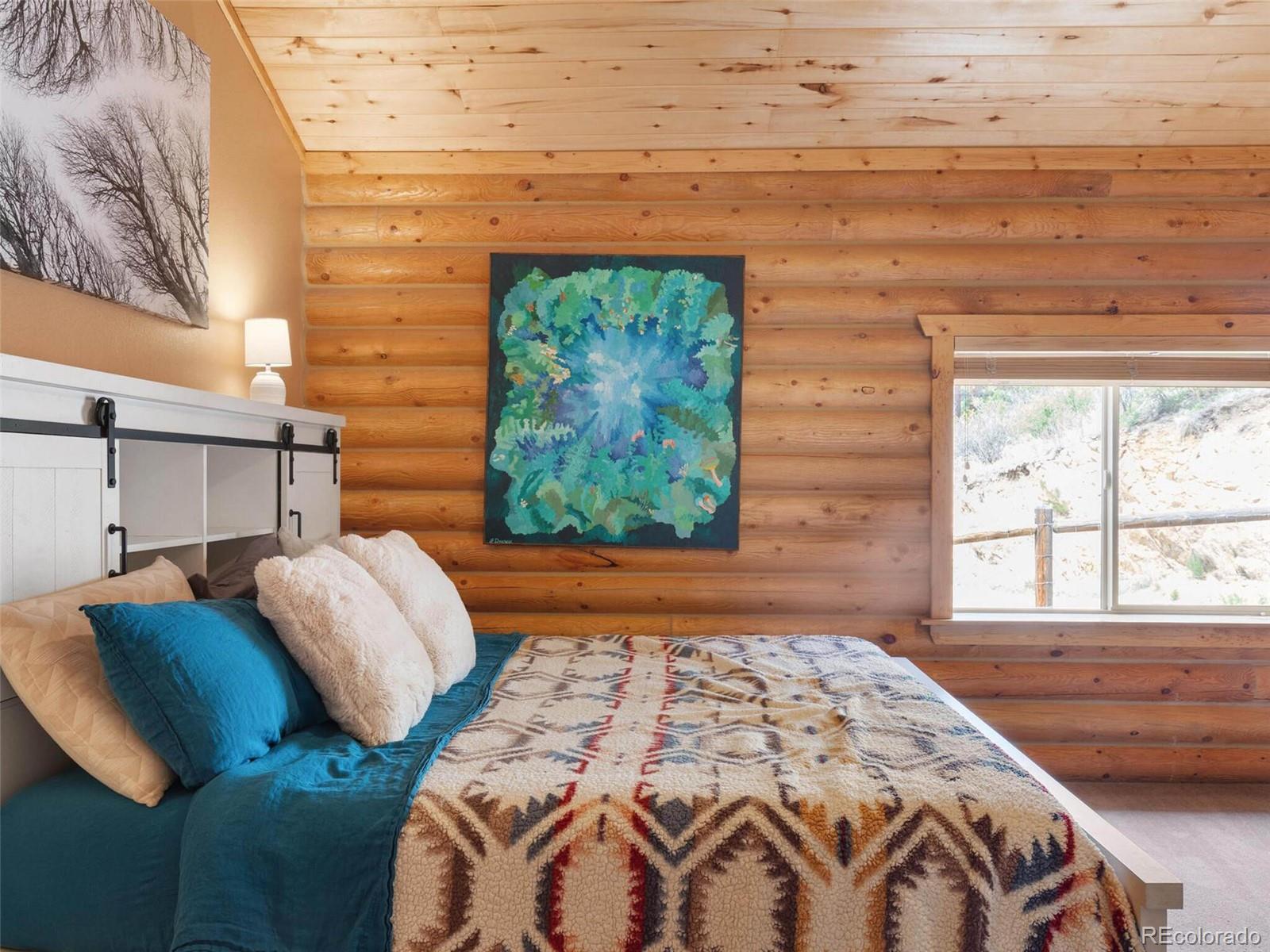 603 Old State Road Bailey, CO 80421 - Photo 25 of 40 a bedroom with a bed and a window