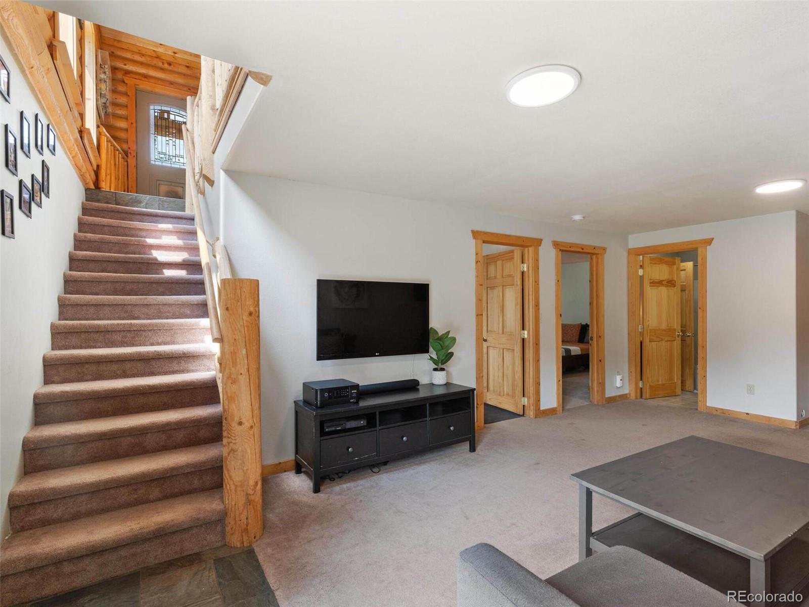 603 Old State Road Bailey, CO 80421 - Photo 29 of 40 a living room with furniture and flat screen tv
