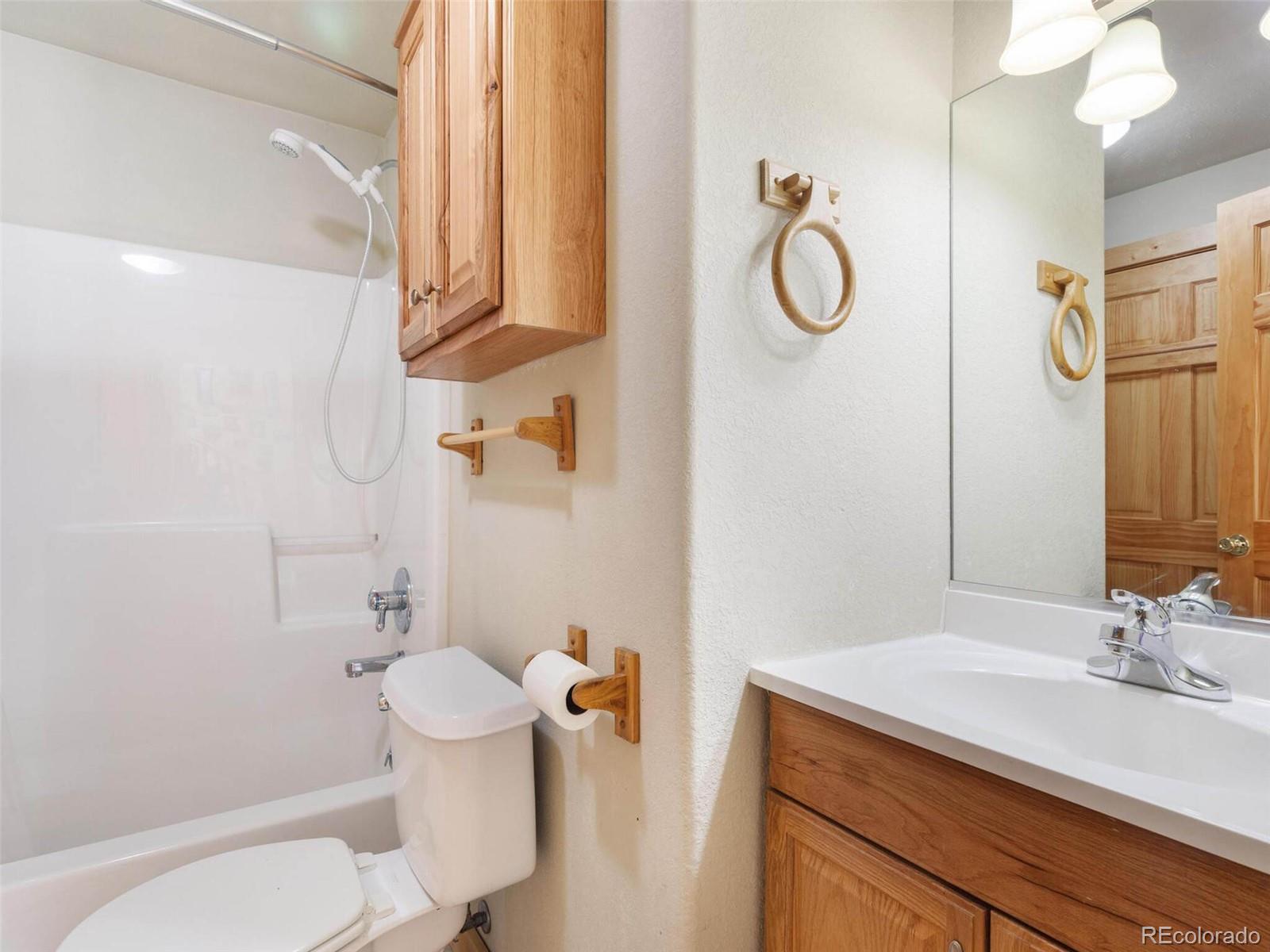 603 Old State Road Bailey, CO 80421 - Photo 36 of 40 a bathroom with a granite countertop sink toilet and shower