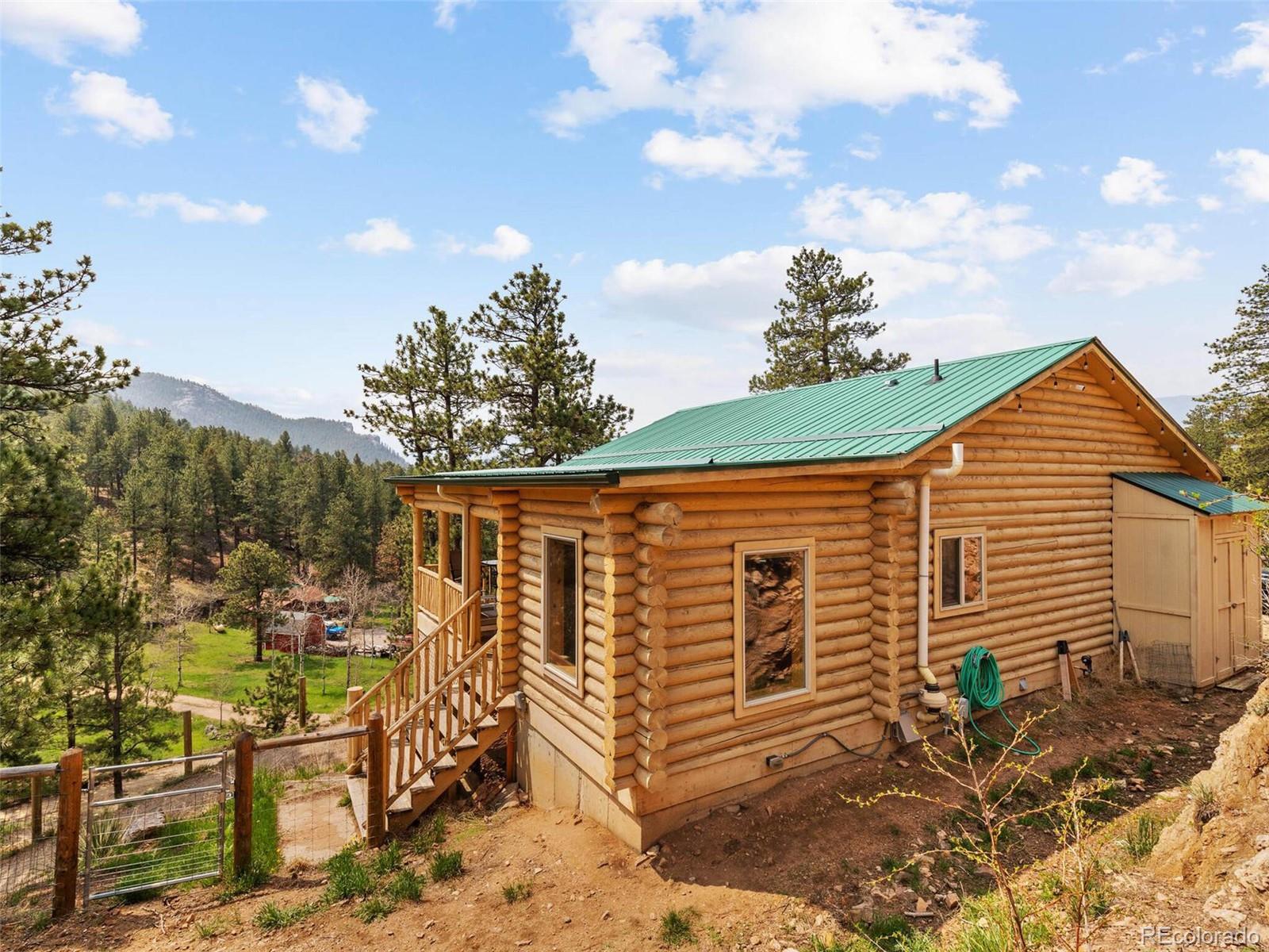 603 Old State Road Bailey, CO 80421 - Photo 39 of 40 a backyard of a house with table and chairs