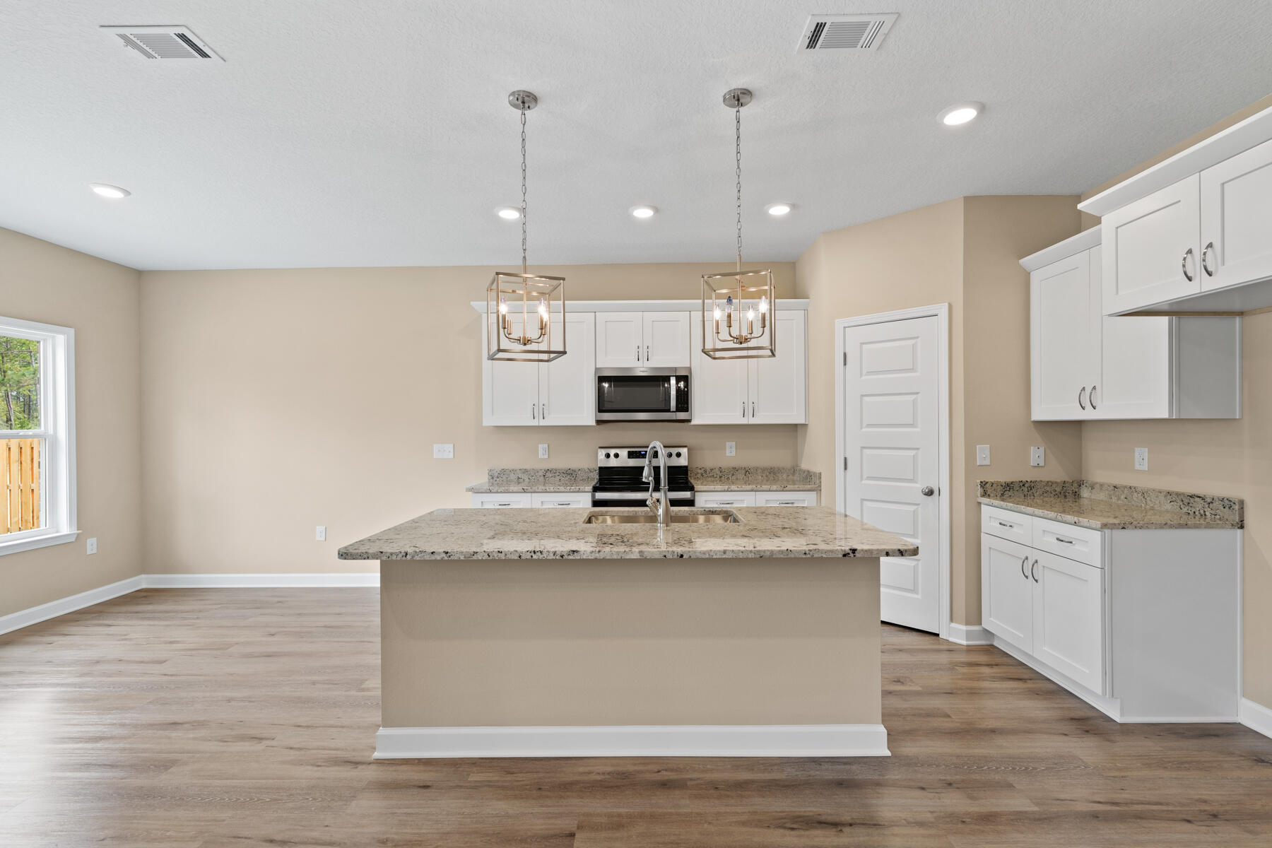 3991 Poverty Creek Road Crestview, FL 32539 - Photo 7 of 16 a large kitchen with stainless steel appliances granite countertop a sink a stove and a refrigerator