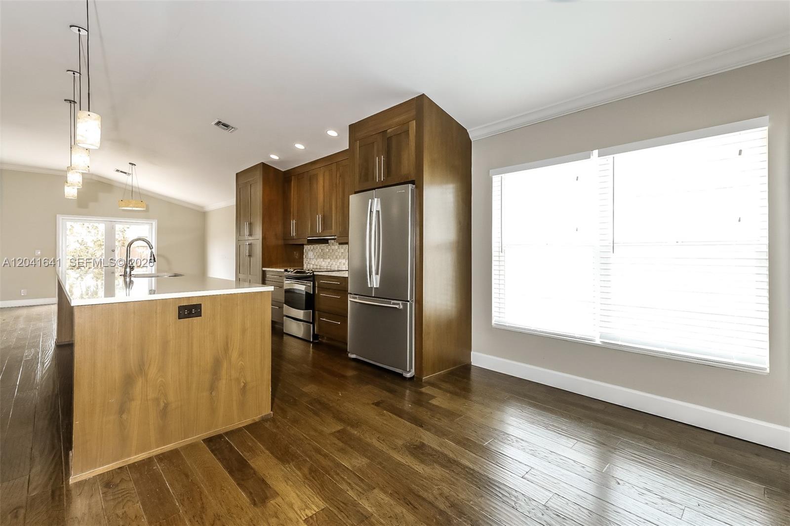6484 Robinson Street Jupiter, FL 33458 - Photo 6 of 15 a kitchen with stainless steel appliances granite countertop a refrigerator a sink a stove and a wooden floors