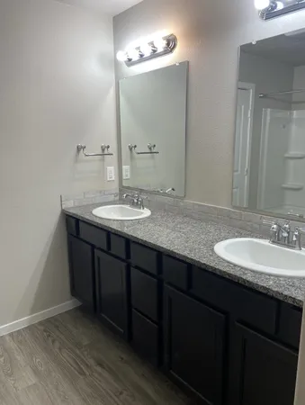 a bathroom with a granite countertop sink a large mirror and a