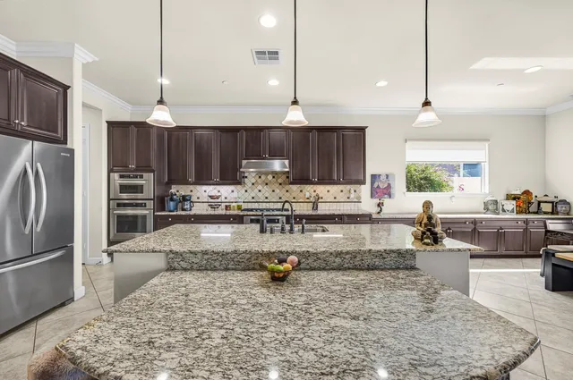 a bedroom with a bed and a flat tv screen on dresser