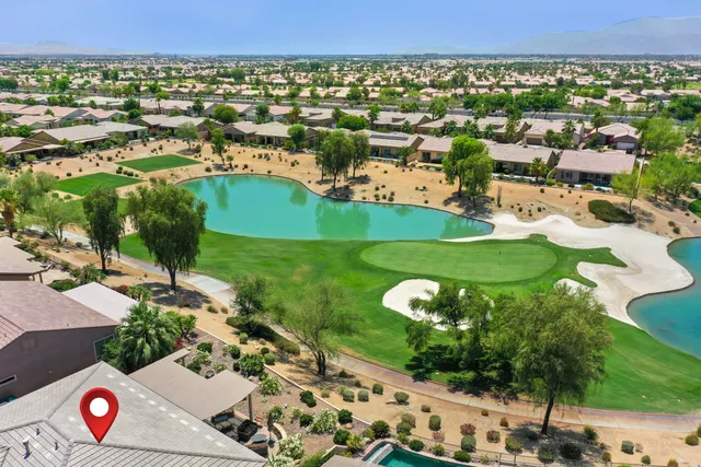 a dining room with furniture a chandelier and wooden floor