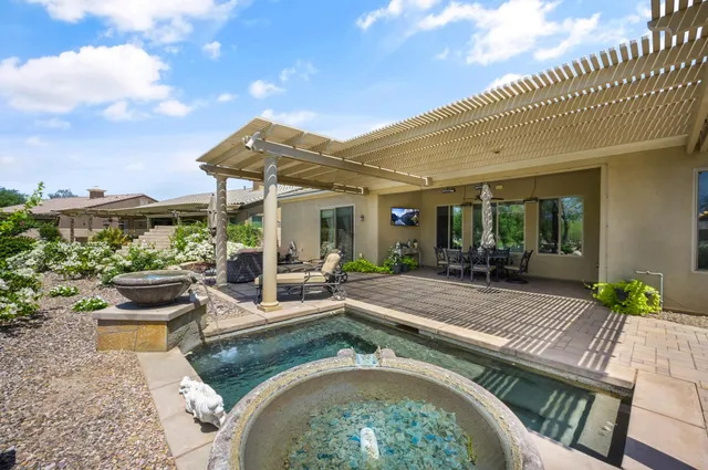 a view of a swimming pool with an outdoor seating