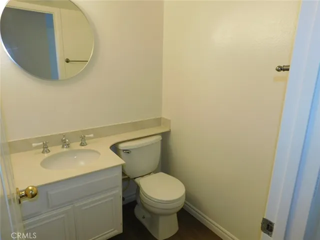 a white toilet sitting next to a bathroom sink