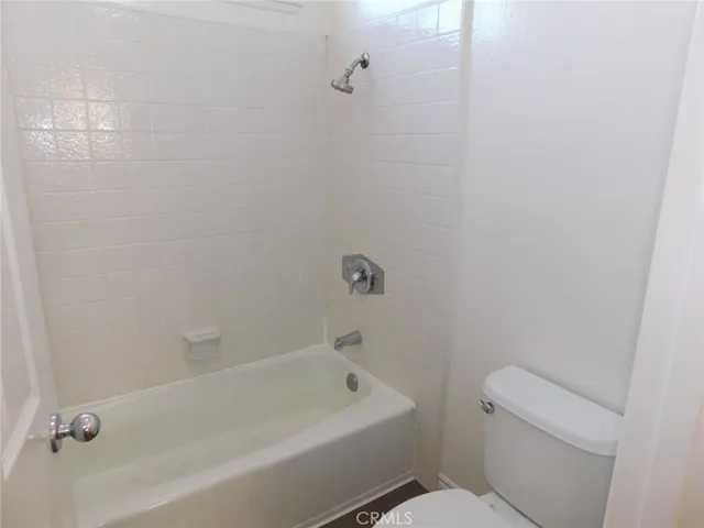 a bath tub sitting next to a white toilet and a sink