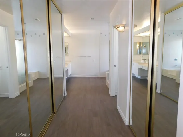 a view of a hallway with wooden shelves