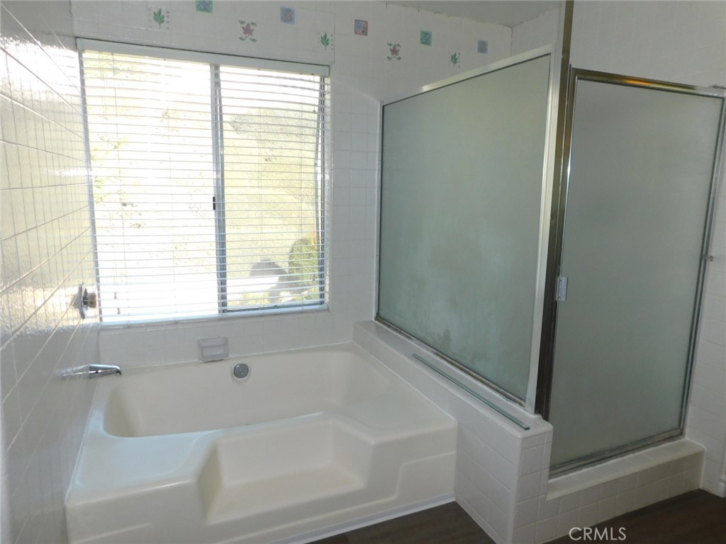 22411 Salmeron Mission Viejo, CA 92691 - Photo 23 of 30 a bathroom with a bathtub and a shower