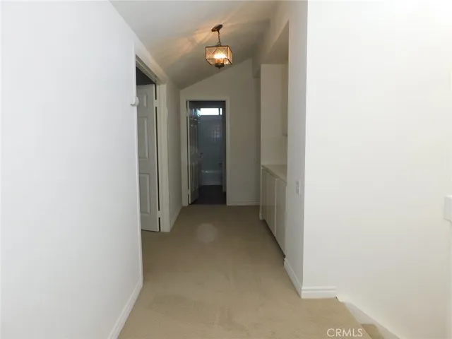 a view of a hallway with chandelier