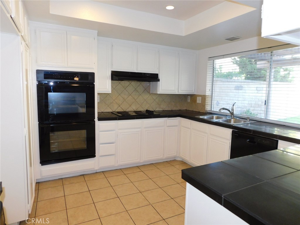 22411 Salmeron Mission Viejo, CA 92691 - Photo 7 of 30 a kitchen with a sink and cabinets
