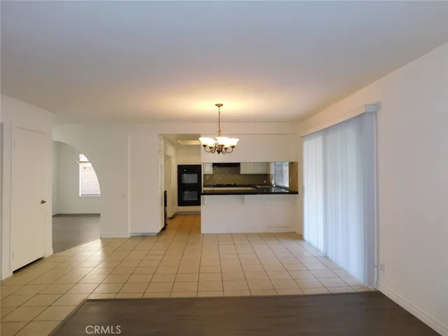 a large kitchen with kitchen island a sink stainless steel appliances and cabinets