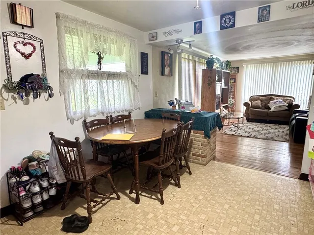 a view of a dining room with furniture and chandelier