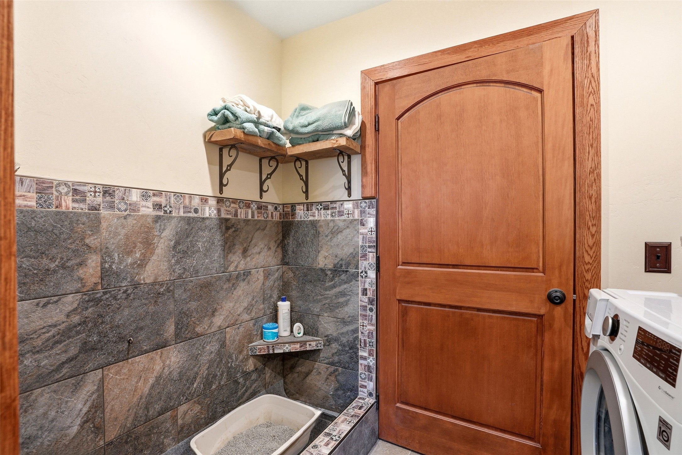 679 Hidden Valley Road North Florence, MT 59833 - Photo 39 of 85 Laundry area featuring a warm wood-panel door with an arched top panel