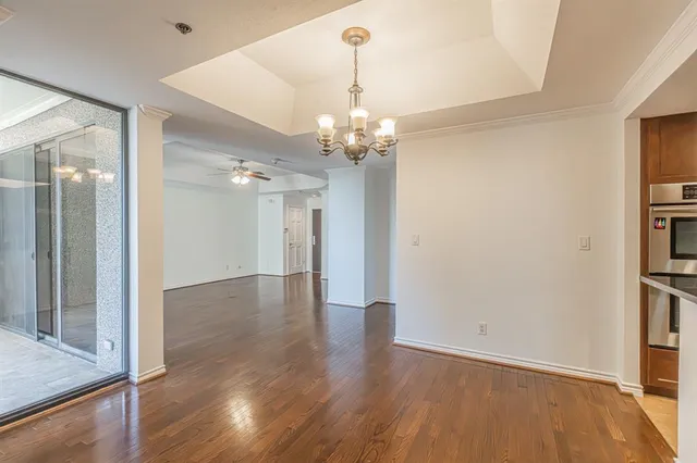 a view of a kitchen with a sink and dishwasher a refrigerator with wooden floor