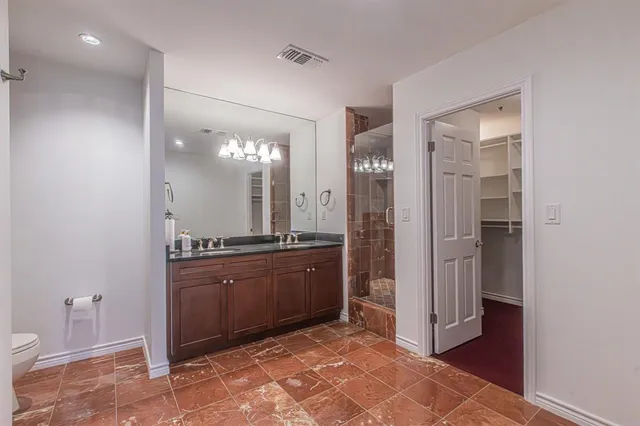 a bathroom with a bathtub shower sink mirror and toilet