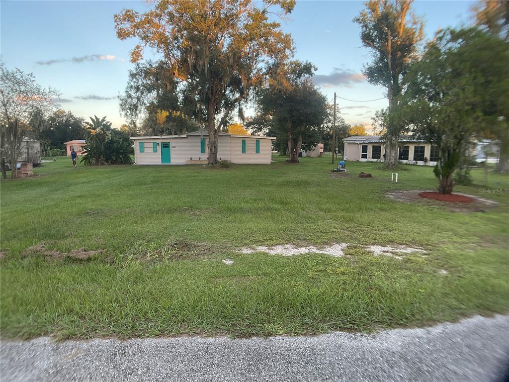 5038 Northeast Sandy Road Arcadia, FL 34266 - Photo 41 of 42 a view of a house with a big yard