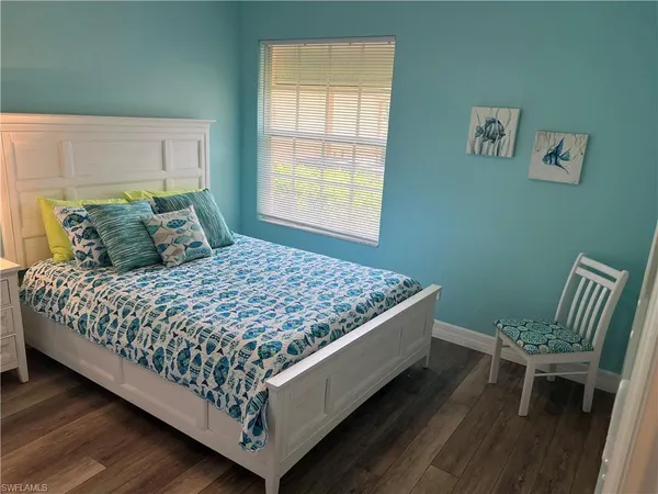 a bed sitting in a bedroom next to a window