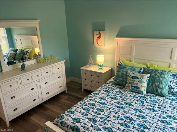 a bedroom with a bed and a dresser