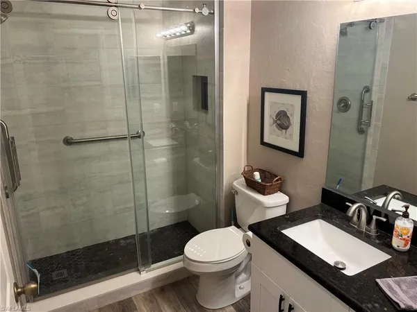 a bathroom with a sink toilet and shower