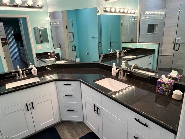 a bathroom with a sink double vanity and a mirror