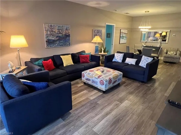 a living room with furniture and a lamp