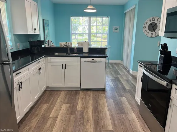 a kitchen with a sink and a stove top oven
