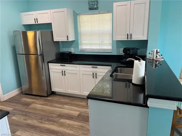 a kitchen with a refrigerator and a sink