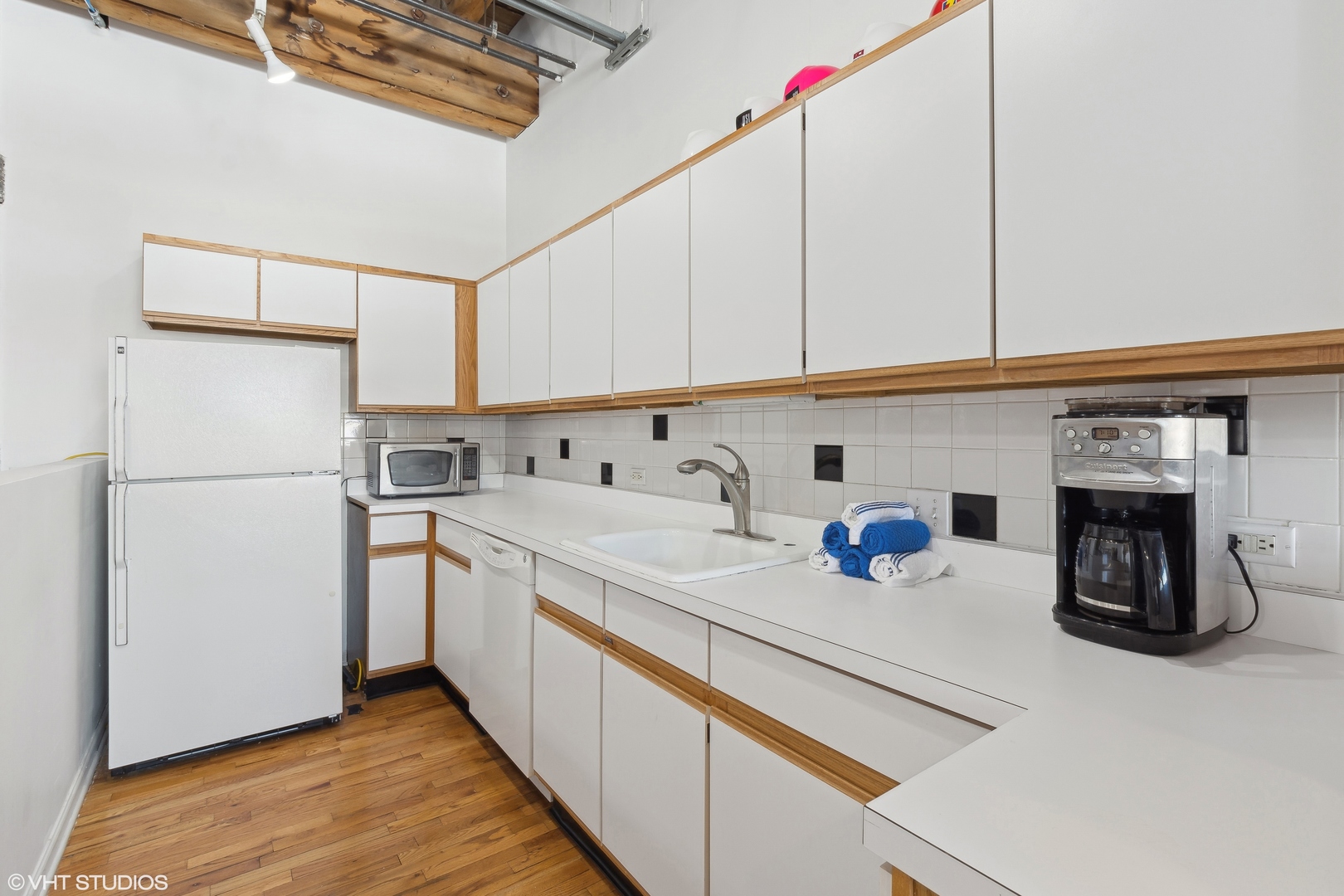 312 North May Street, Unit 2F Chicago, IL 60607 - Photo 5 of 15 a kitchen with stainless steel appliances a refrigerator sink and cabinets
