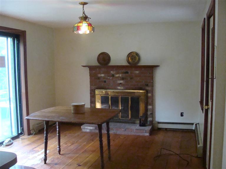 a view of a livingroom with furniture and a fireplace