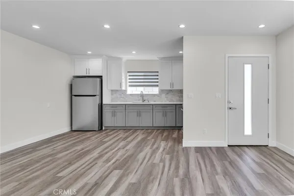 a view of kitchen with refrigerator and window